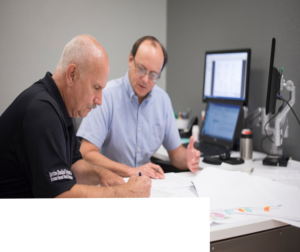 Two members of the HFS team discussing a project