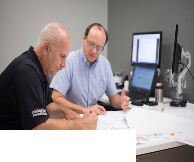 Two members of the HFS team discussing a project